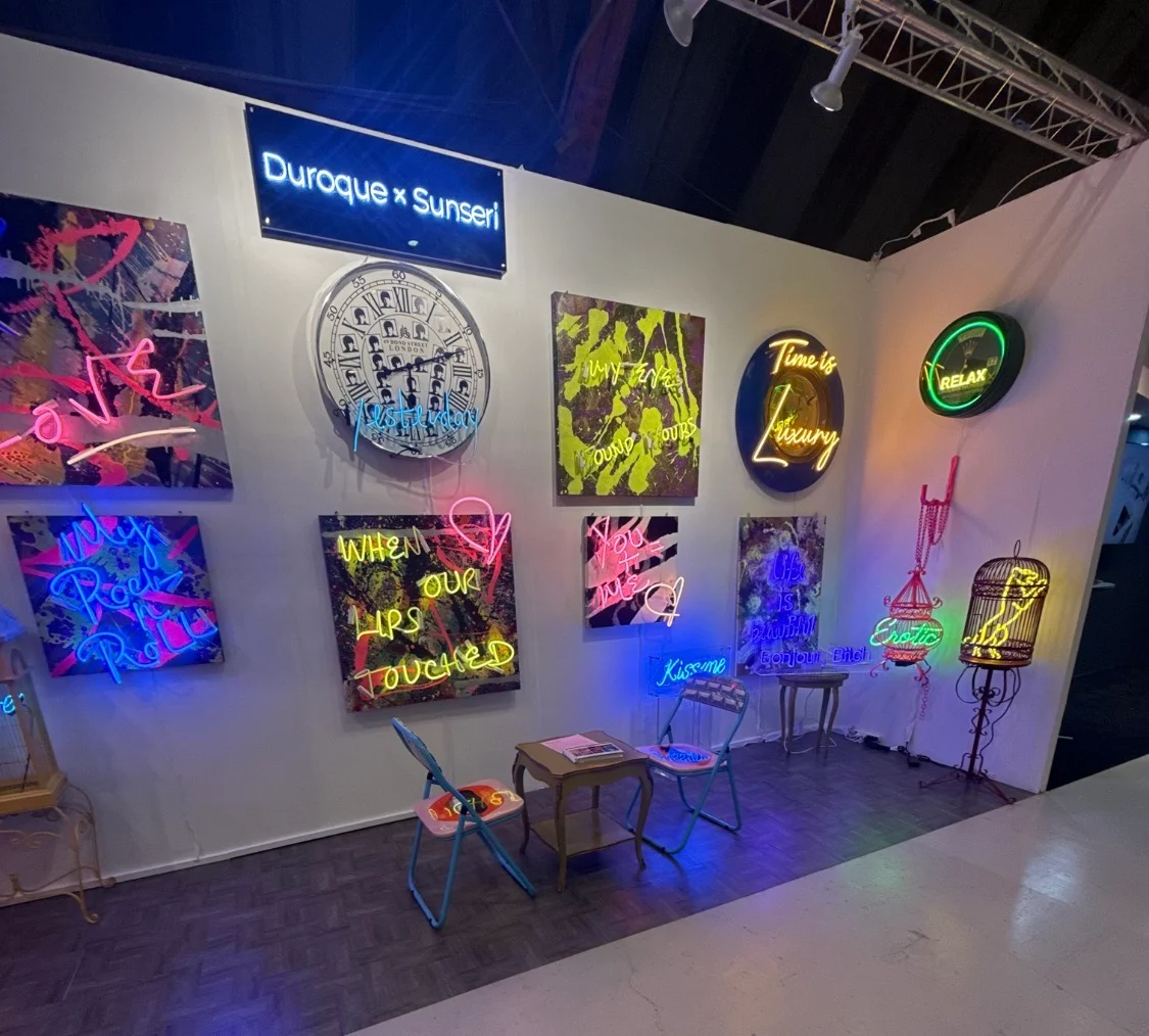 Missy Sunseri's exhibition installation at Barker Hangar, 2025, showing paintings and real glass neon artworks on white gallery walls